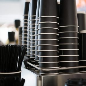 black-paper-cups-on-a-counter-against-the-backgrou-2023-11-27-05-36-21-utc-scaled-1.jpg