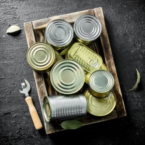 closed-cans-of-canned-food-on-a-wooden-tray-2023-11-27-05-08-34-utc-scaled-1.jpg